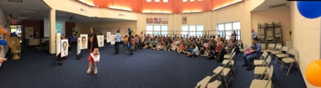 Wide angle photo of auditorium with all of the children who attended the event